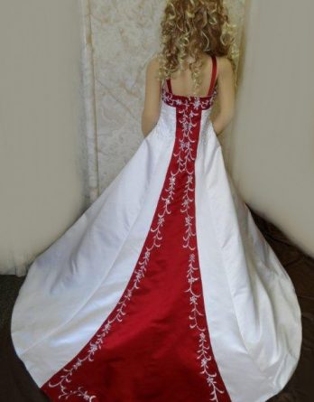 White miniature wedding, flower girl dress with colorful red, accented with and white embroidery running down the train.