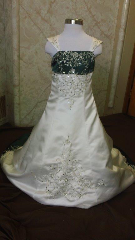 Ivory flower girl dress with green trimmed bodice, and sweep train, accented with crystal beaded embroidery.