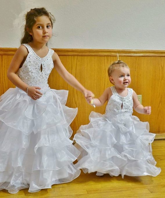 Adorable flower girls, dressed in beads and ruffles