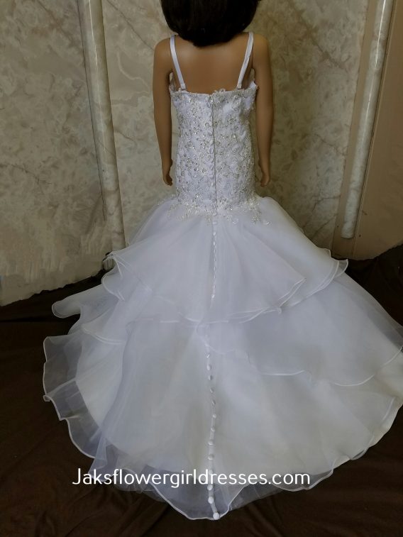 An organza mermaid flower girl dress with a sweetheart neck and ruffle tiered train.