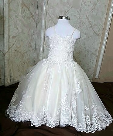 Champagne flower girl dress with a long lace train.  Satin spaghetti strap dress has elegant lace applique and scalloped lace train.