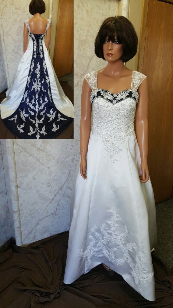 Navy blue and white wedding dress. Navy blue trimmed neckline, lace up back and chapel train with beaded lace applique.