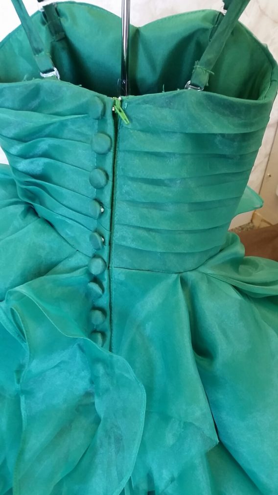 Emerald green organza ruffle flower girl dress designed to match a wedding dress. 