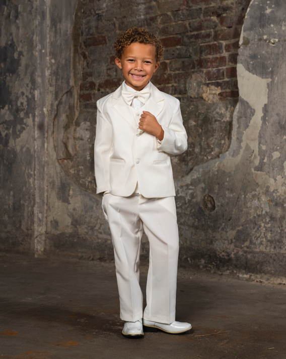 Boys 5-piece ivory tuxedo for infants to teenagers. Black, Ivory, or White Tuxedo includes a jacket, pants, vest, shirt, and a bow tie.