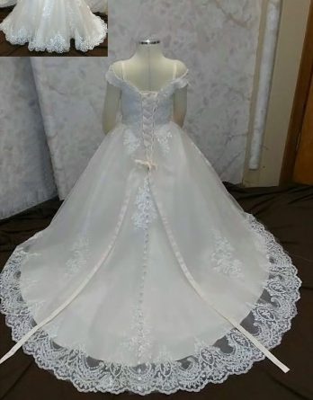 Champagne flower girl dress with a long lace train.  Satin spaghetti strap dress has elegant lace applique and scalloped lace train.