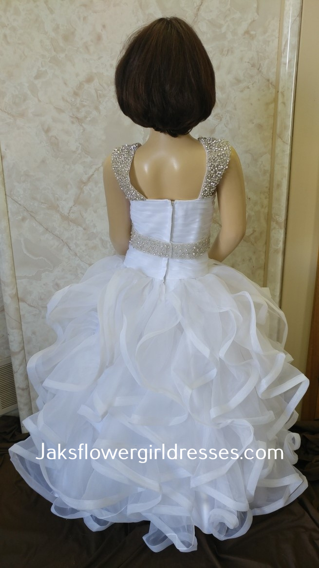 Flower girl dress with ruffle skirt and beaded straps, and waist.