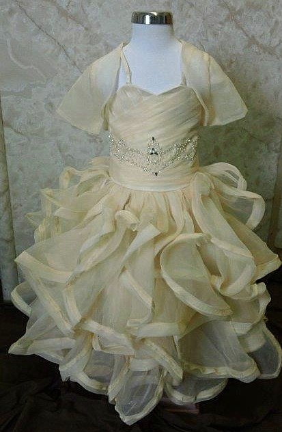 Ivory flower girl dress with ruffle skirt, and a jacket.
