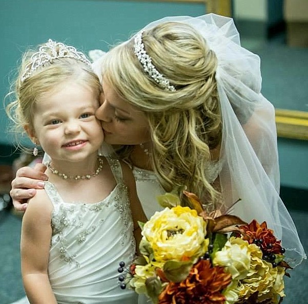 This little toddler flower girl is dressed to match the bride.