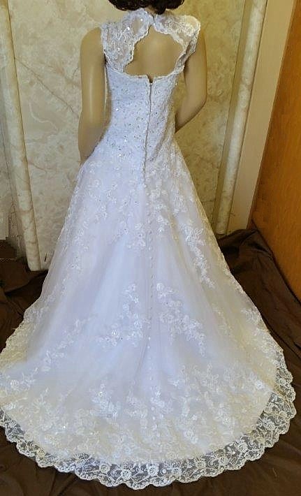 Open back lace flower girl dress with fabric covered buttons along the entire length of the chapel length train.