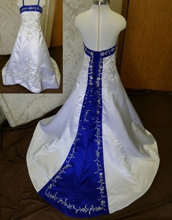 White dress for wedding flower girls. Royal blue trimmed neckline, lace up back and chapel train with beaded embroidery.