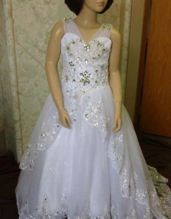 Elaborate flower girl dresses with sheer shoulder straps with elaborate crystal jewels. Brilliant jewels cascade down the bodice.