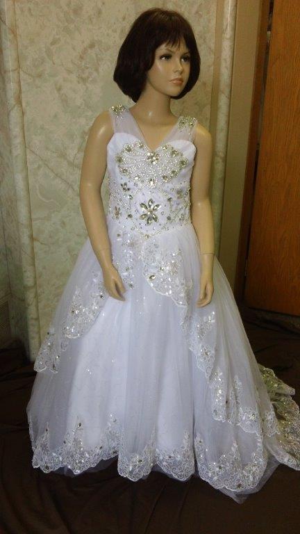 Elaborate flower girl dresses with sheer shoulder straps with elaborate crystal jewels. Brilliant jewels cascade down the bodice.