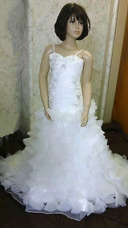 Organza fit and flare flower girl gown with a ruffle train.