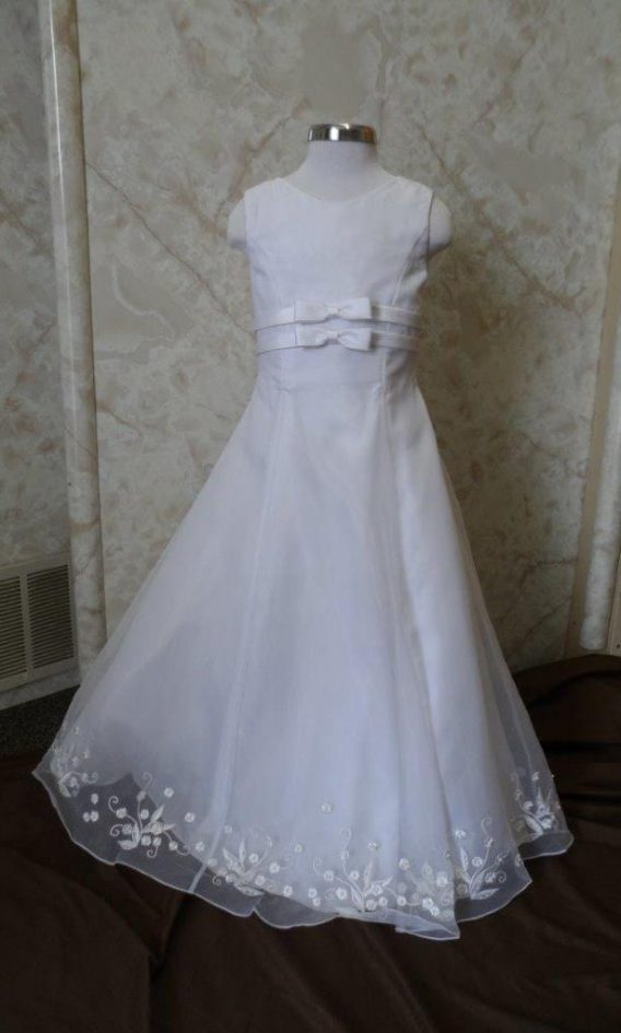 Long white sleeveless bargain flower girl dresses. Empire waist bows, and embroidered hem line. On sale for $40.