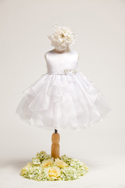 Lovely white baby dress. Sleeveless satin bodice with organza ruffle skirt. Flower decoration on the side of waistband.