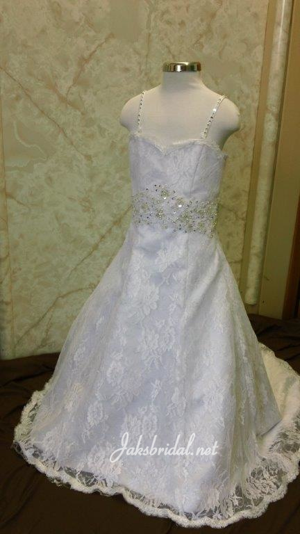 White lace flower girl dress with train. A line sweetheart gown with silver and pearl beaded shoulder straps and belt.