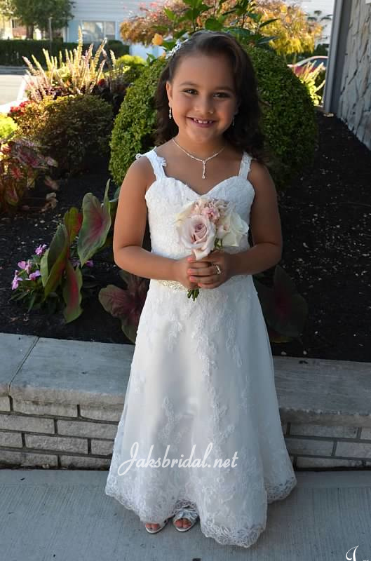 Beautiful flower girl in her matching bridal gown