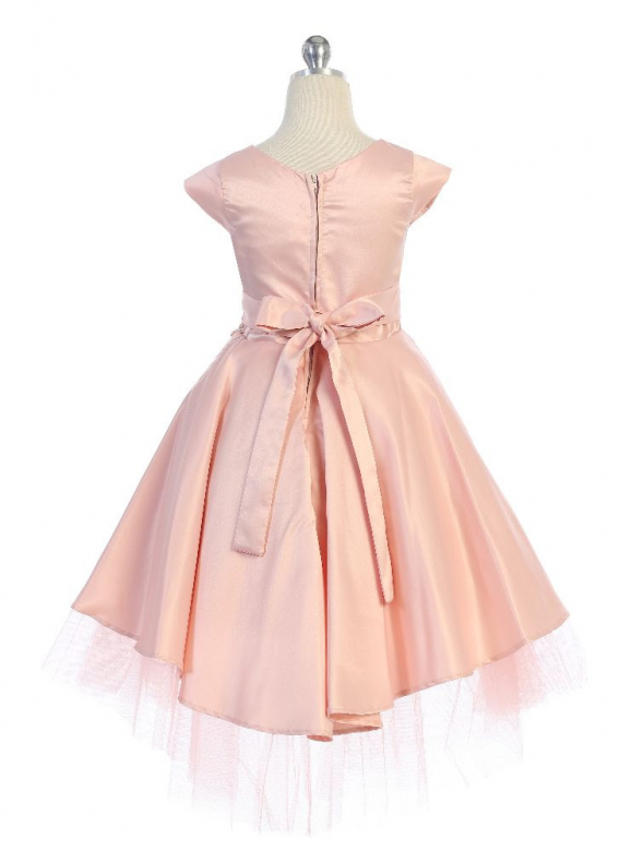 Girls blush cap sleeve dress has a high low peplum skirt with tiered tulle underlay. Flower waist accent, and sash back.