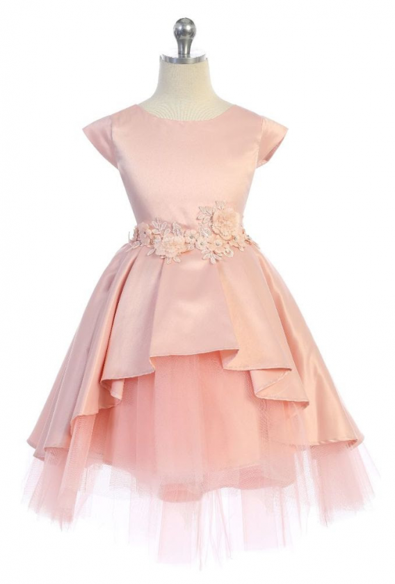 Girls Blush cap sleeve dress has a high low peplum skirt with tiered tulle underlay. Flower waist accent, and sash back.