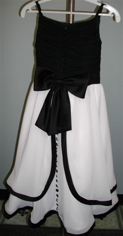A black organza bodice and ivory skirt, with black sash, trim, and buttons flowing down the back of the dress. On sale for $50.
