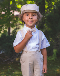 Sand-colored Suspender outfit. Boy suspender set includes shorts with matching suspenders and bow tie, and a white short-sleeve shirt.