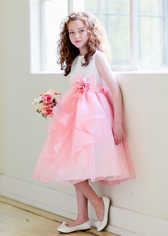 Darling coral toddlers dress with tiered bow flowing down the front makes it more adorable.  On sale.