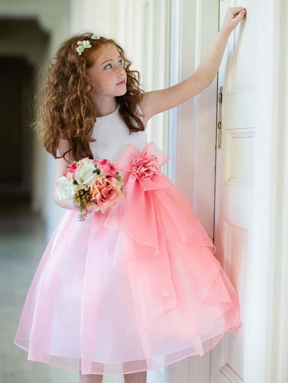 Darling coral toddlers dress with tiered bow flowing down the front makes it more adorable.  On sale.