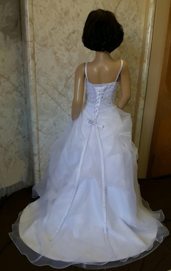 This handmade flower girl dress has a pleated sweetheart bodice with a beaded waist. Completed with a corset lace-up back, and small train.