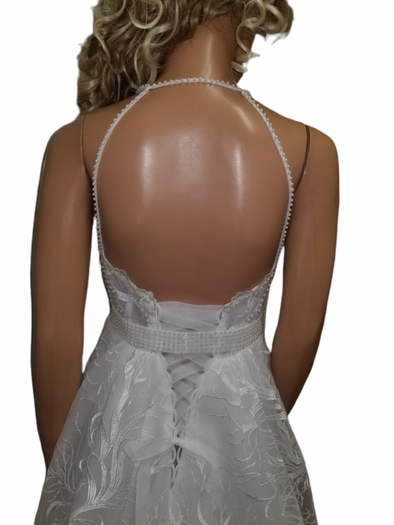 Bohemian wedding dress with beaded halter neckline creates an open back.