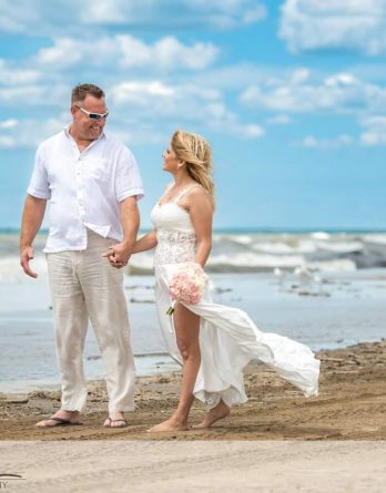Beach Wedding Dress with a See-Through Middle, flowing skirt with flirty slit at the side of the leg.