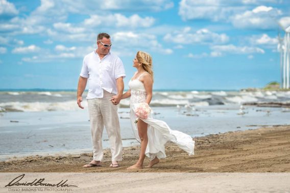 Beach Wedding Dress with a See-Through Middle, flowing skirt with flirty slit at the side of the leg.