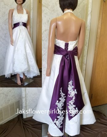 Halter wedding dress with hand-pattern lace, waistline accented with contrasting band and back streamers, completed with a high low skirt with front split.