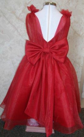 Girls long A-line apple red organza flower girl dress with a v-back and bow on the waist.