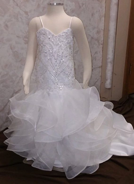 This mermaid flower girl dress with an elaborate hand-beaded bodice will be worn by a tiny 5-year-old flower girl.