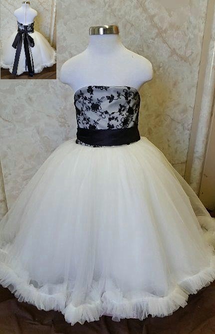 Floor-length black and ivory tulle flower girl dress. Black lace bodice and sash.