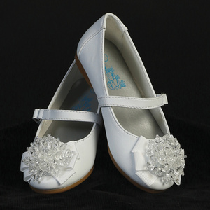 Girls white slip-on ballet flats feature a sparkling adornment. This shoe has a grosgrain and gemstone bow embellishment on the toe box. Infant sizes come with a strap.