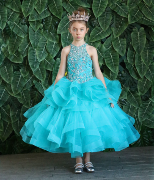 Girls capri ruffled ball gowns with a beaded halter neckline and ruffled layer skirt.