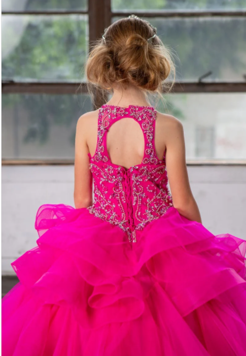 Girls magenta ruffled ball gowns with a beaded halter neckline and ruffled layer skirt.