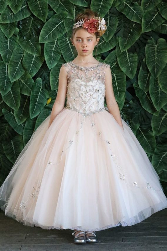 Sleeveless girl's ball gown has an embellished bodice, illusion neckline, and voluminous skirt