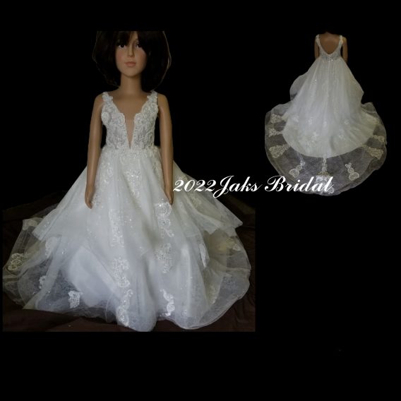 A stunning wedding & flower girl dress pair. White pearl tulle over sequined tulle featuring a sleeveless bodice and a plunging V-neck neckline.