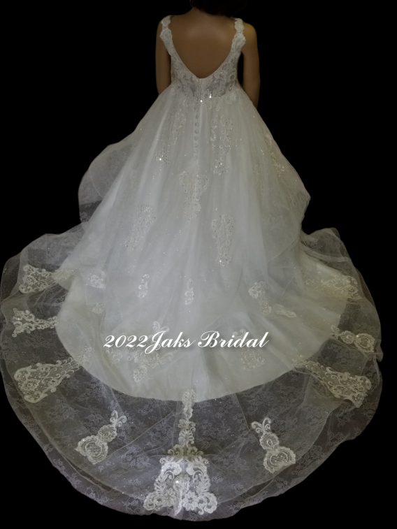 A stunning wedding & flower girl dress pair. White pearl tulle over sequined tulle featuring a sleeveless bodice and a plunging V-neck neckline.